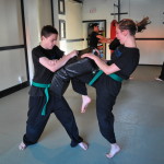 Youth Kneeing During Martial Arts Class